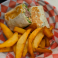 Grilled wrap filled with seasoned meat, lettuce, and cheese served with thick-cut fries.