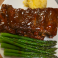 BBQ pork ribs served with asparagus and mashed potatoes.