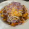 French fries topped with hearty chili, shredded cheese, and diced red onions.