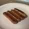 Four grilled breakfast sausage links.