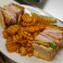 Ham, turkey, bacon, Swiss and American cheese, lettuce, tomato, and mayo all assembled on your choice of toasted bread.