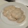 Single biscuit covered with creamy sausage gravy.