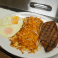 Grilled ranch steak with eggs and hash browns.