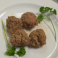 Side order of four meatballs garnished with parsley.
