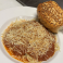 Spaghetti with marinara sauce, Parmesan cheese, and garlic bread.