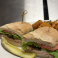 Turkey, bacon, and avocado sandwich served on fresh bread with waffle fries.