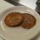 Two grilled breakfast sausage patties.