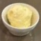 Single scoop of vanilla ice cream served in a small bowl.